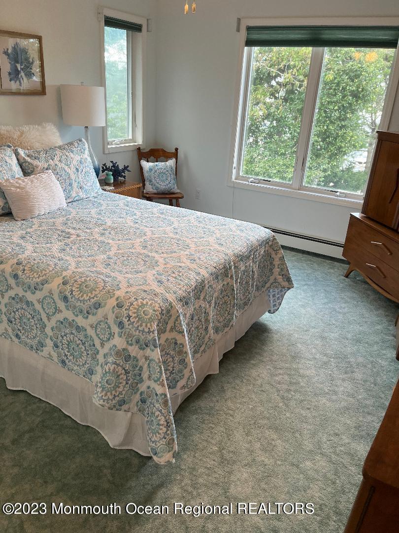 64 Van Ness Drive Brick, NJ 08723 - Photo 24 of 25 a bedroom with a bed and glass window