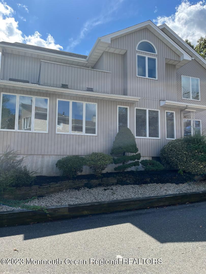 64 Van Ness Drive Brick, NJ 08723 - Photo 4 of 25 a front view of a house with a yard
