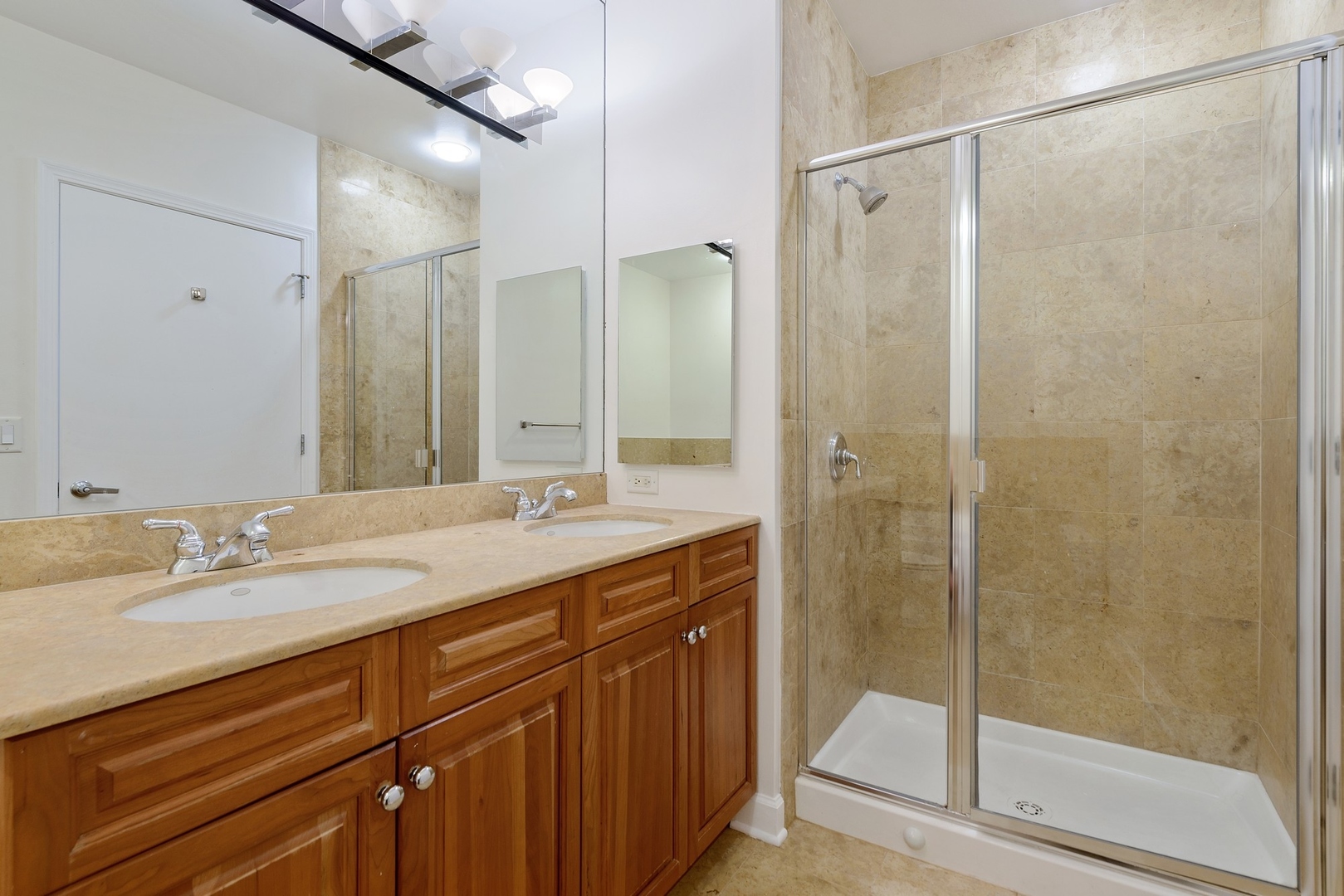 1322 South Prairie Avenue, Unit 302 Chicago, IL 60605 - Photo 11 of 13 a bathroom with a shower sink vanity and mirror