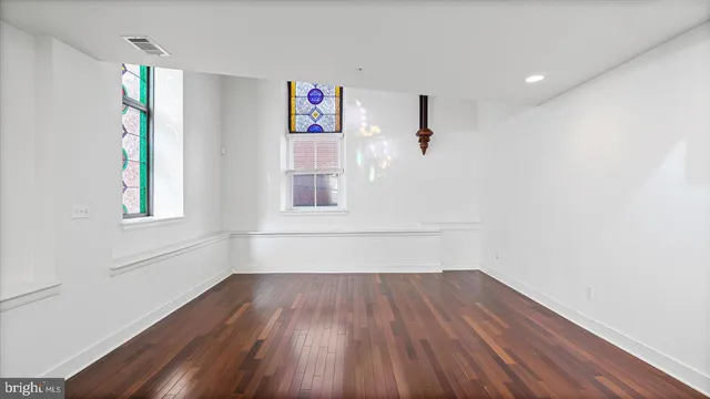 a view of a room with wooden floor and window
