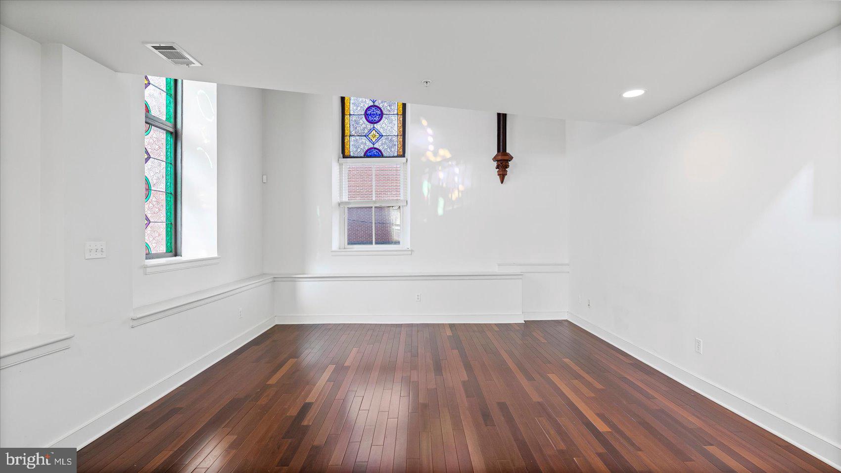 1100 North Calvert Street, Unit 2 Baltimore, MD 21202 - Photo 11 of 34 a view of a room with wooden floor and window