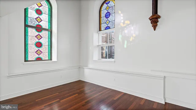 a view of small space with wooden floor and windows