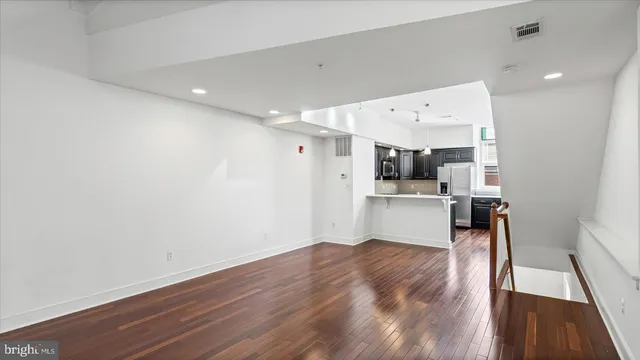 a view of a kitchen with wooden floor