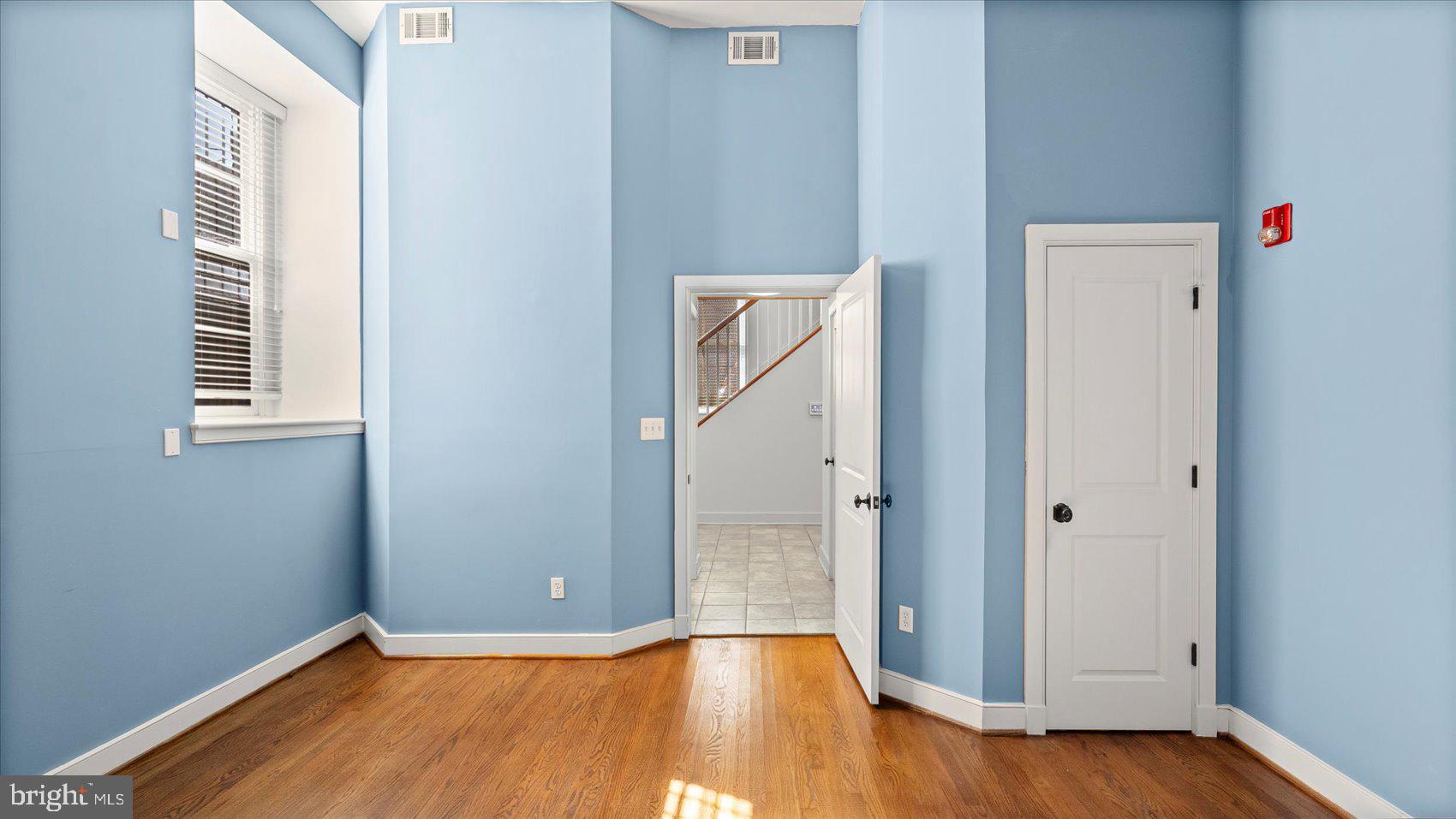 1100 North Calvert Street, Unit 2 Baltimore, MD 21202 - Photo 17 of 34 a view of an empty room with wooden floor and a window