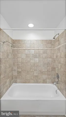 a bathroom with a shower and a bathtub