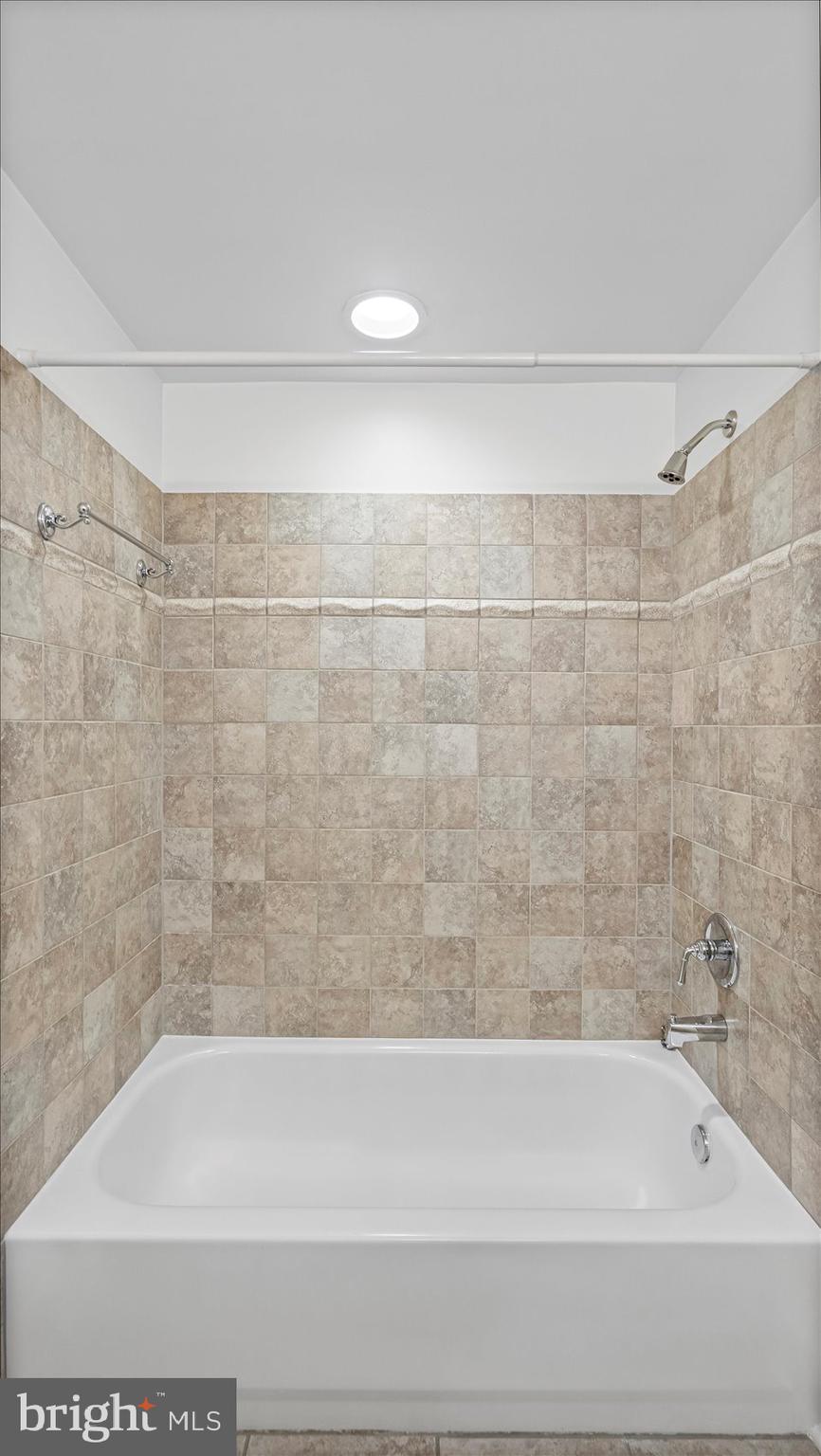 1100 North Calvert Street, Unit 2 Baltimore, MD 21202 - Photo 19 of 34 a bathroom with a shower and a bathtub
