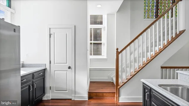a view of a hallway with wooden floor and staircase