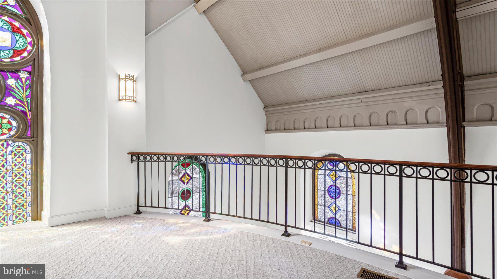 1100 North Calvert Street, Unit 2 Baltimore, MD 21202 - Photo 29 of 34 a view of a hallway with wooden floor and windows