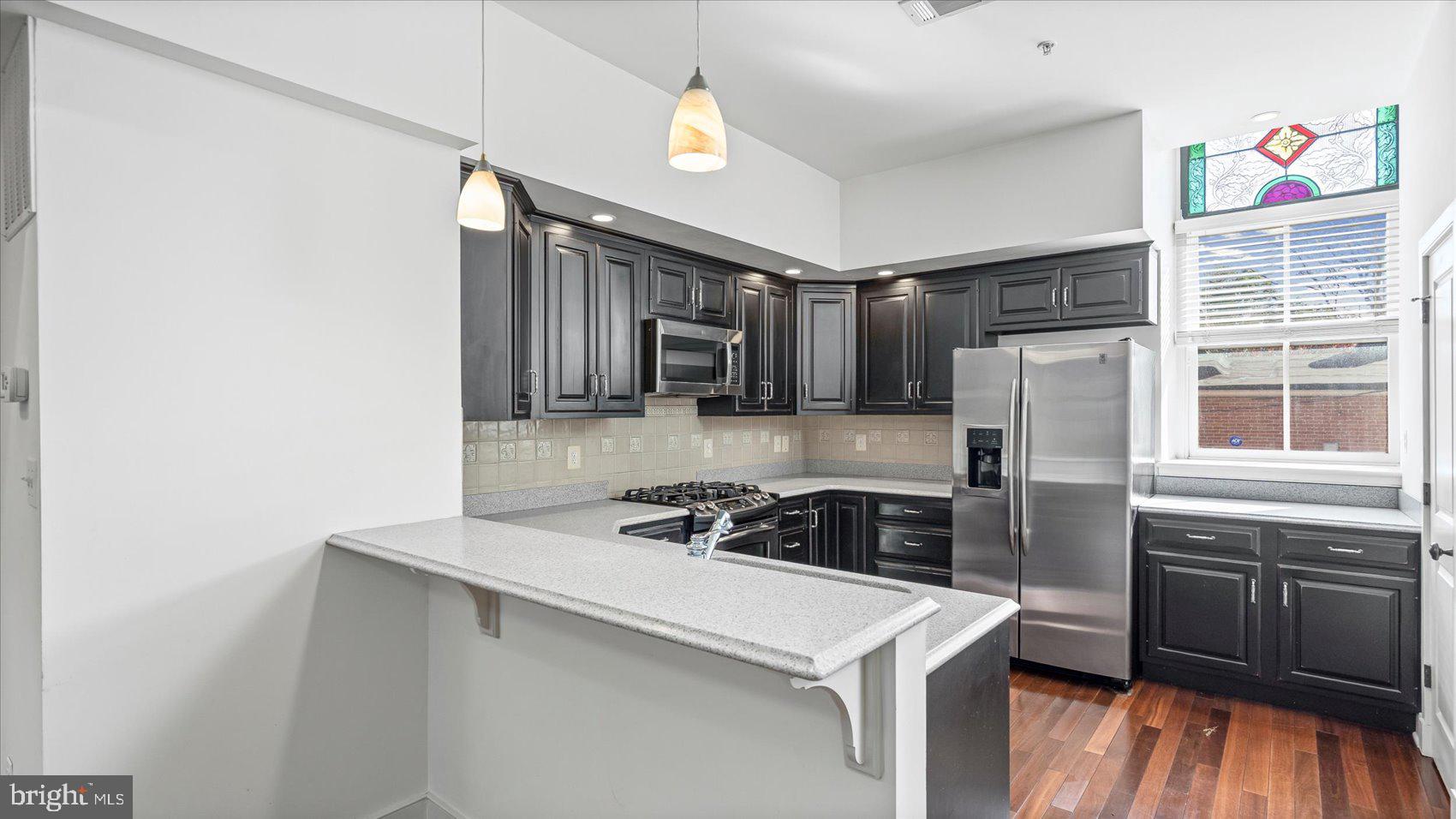 1100 North Calvert Street, Unit 2 Baltimore, MD 21202 - Photo 3 of 34 a kitchen that has a sink cabinets counter space and appliances