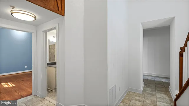 a view of a hallway with closet and bathroom view