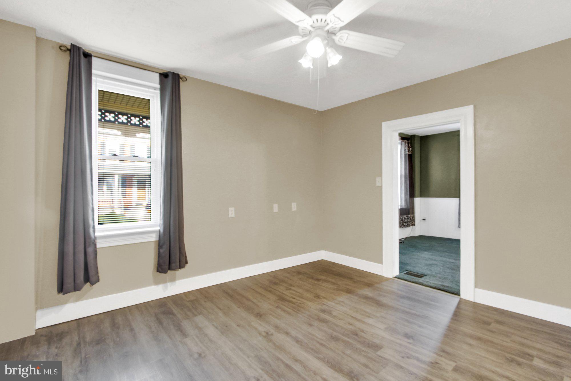 2861 Centennial Road Hanover, PA 17331 - Photo 7 of 26 a view of an empty room with wooden floor and a window