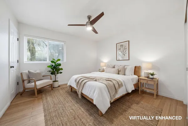 a spacious bedroom with a bed and a couch