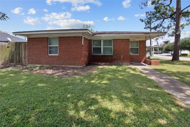 a backyard of a house with table and chairs
