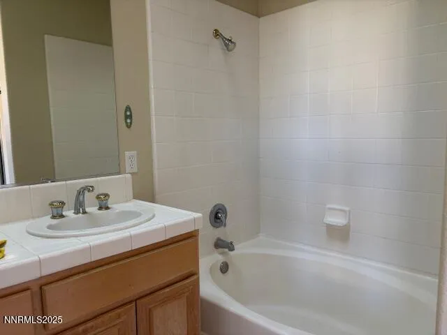 a white bath tub sitting next to a white sink