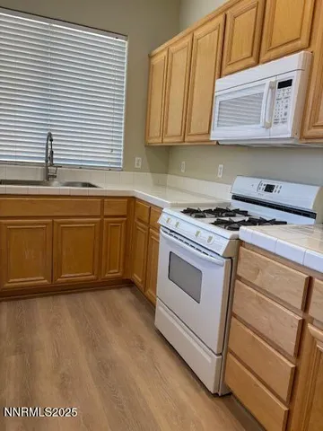 a kitchen with stainless steel appliances granite countertop a stove a sink and dishwasher
