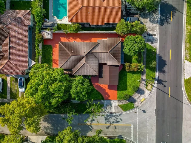 an aerial view of residential houses with outdoor space and street view
