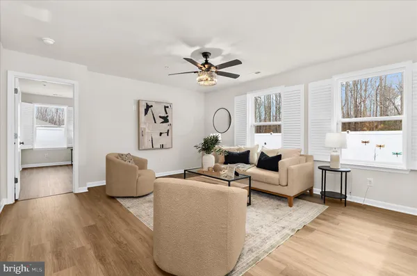 a living room with furniture or chandelier and a window