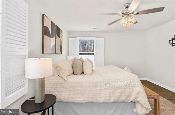 a bedroom with a bed and a lamp