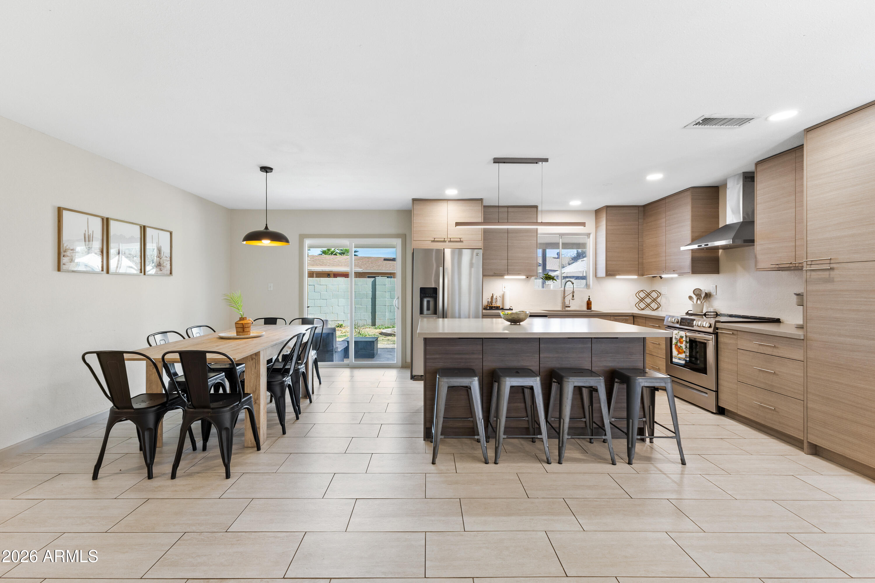 111 South Cholla Street Gilbert, AZ 85233 - Photo 7 of 34 a kitchen with kitchen island a dining table and chairs