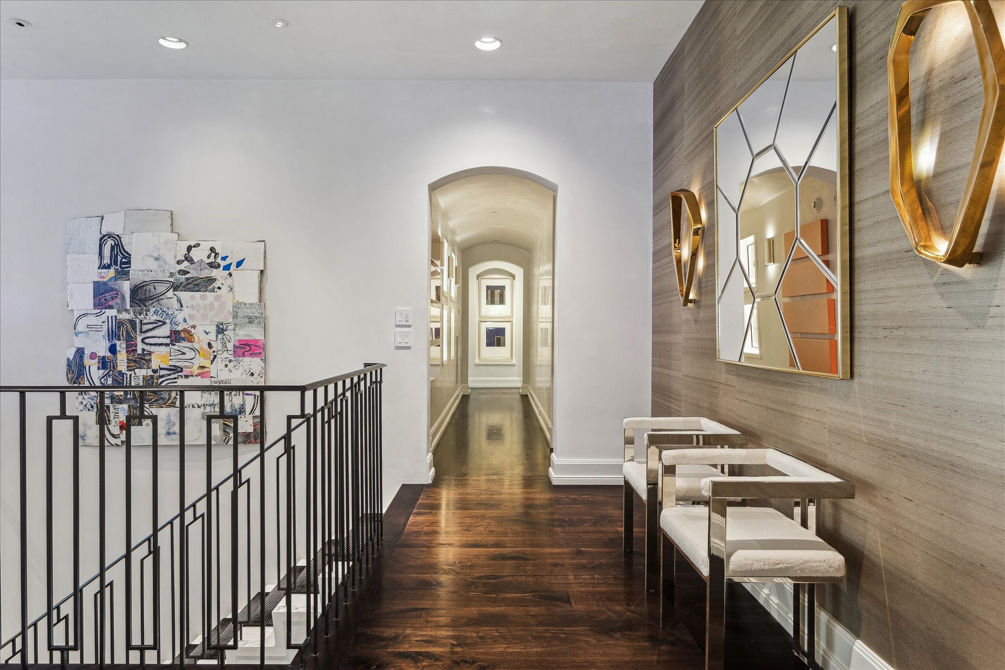 220 Merrie Way Lane Houston, TX 77024 - Photo 31 of 50 This upstairs hallway is lined with arched openings and Segreto plaster walls, with illuminated art niches running the length of the corridor—an ideal gallery-style display for your collection.