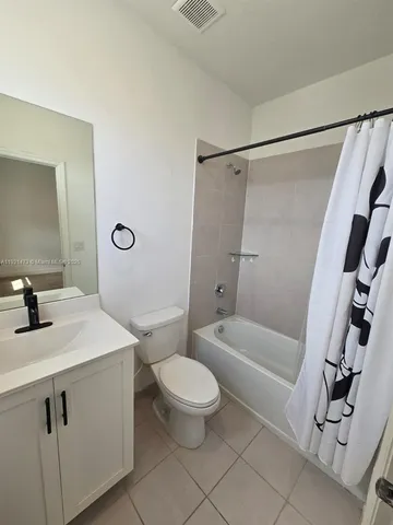 a bathroom with a sink a toilet a mirror a vanity and shower