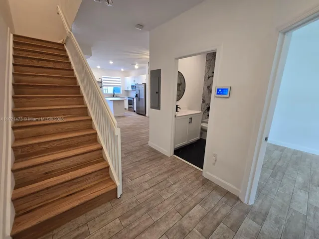 a view of entryway and hall with wooden floor