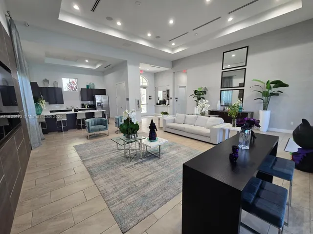 a living room with furniture flat screen tv and window