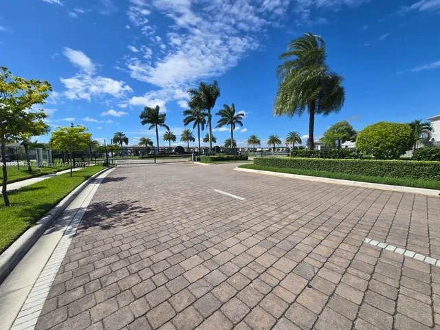 a view of a park with a pathway and a yard