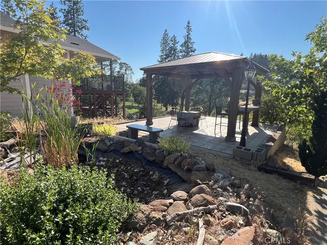 a view of a backyard with sitting area