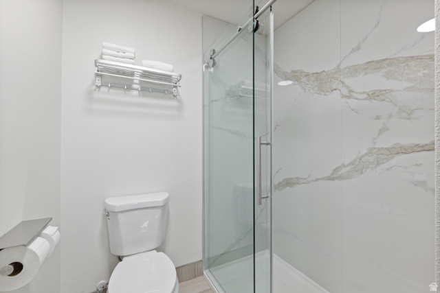 245 Red Cliffs Drive, Unit 104 St. George, UT 84790 - Photo 12 of 33 Full bath with toilet and a marble finish shower