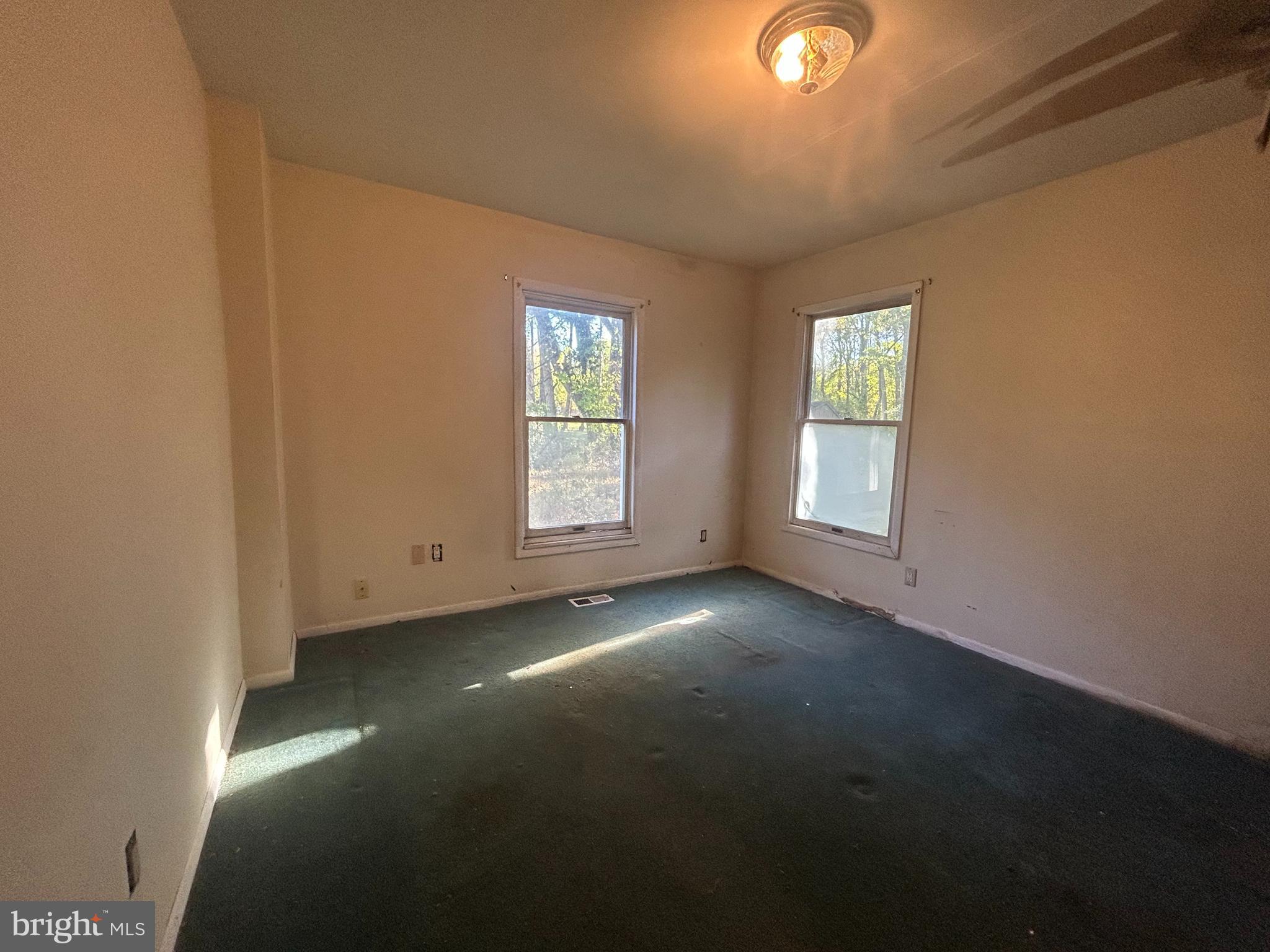 15325 Holly Grove Road Silver Spring, MD 20905 - Photo 11 of 27 an empty room with windows
