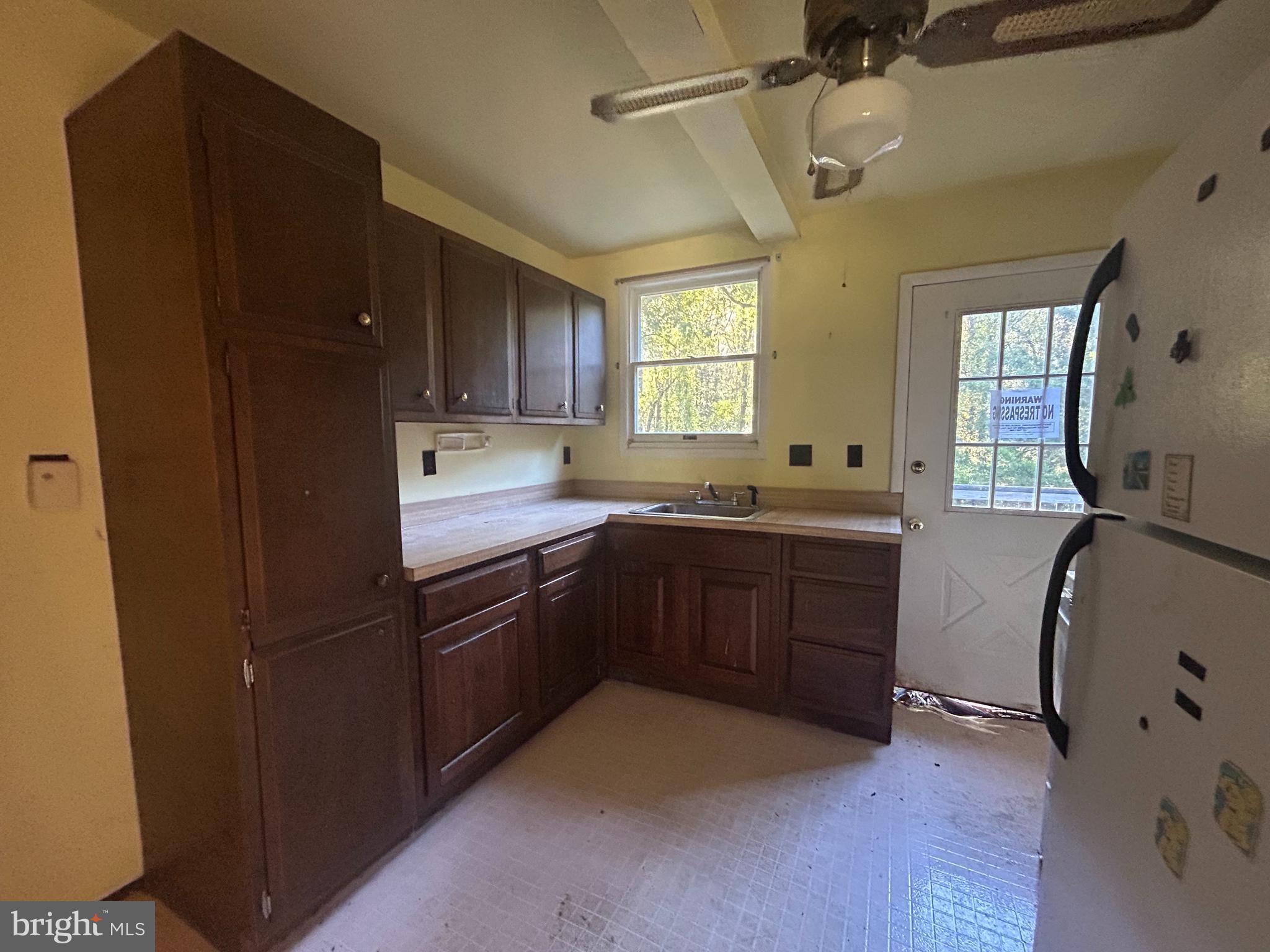 15325 Holly Grove Road Silver Spring, MD 20905 - Photo 15 of 27 a kitchen with a sink stove and refrigerator