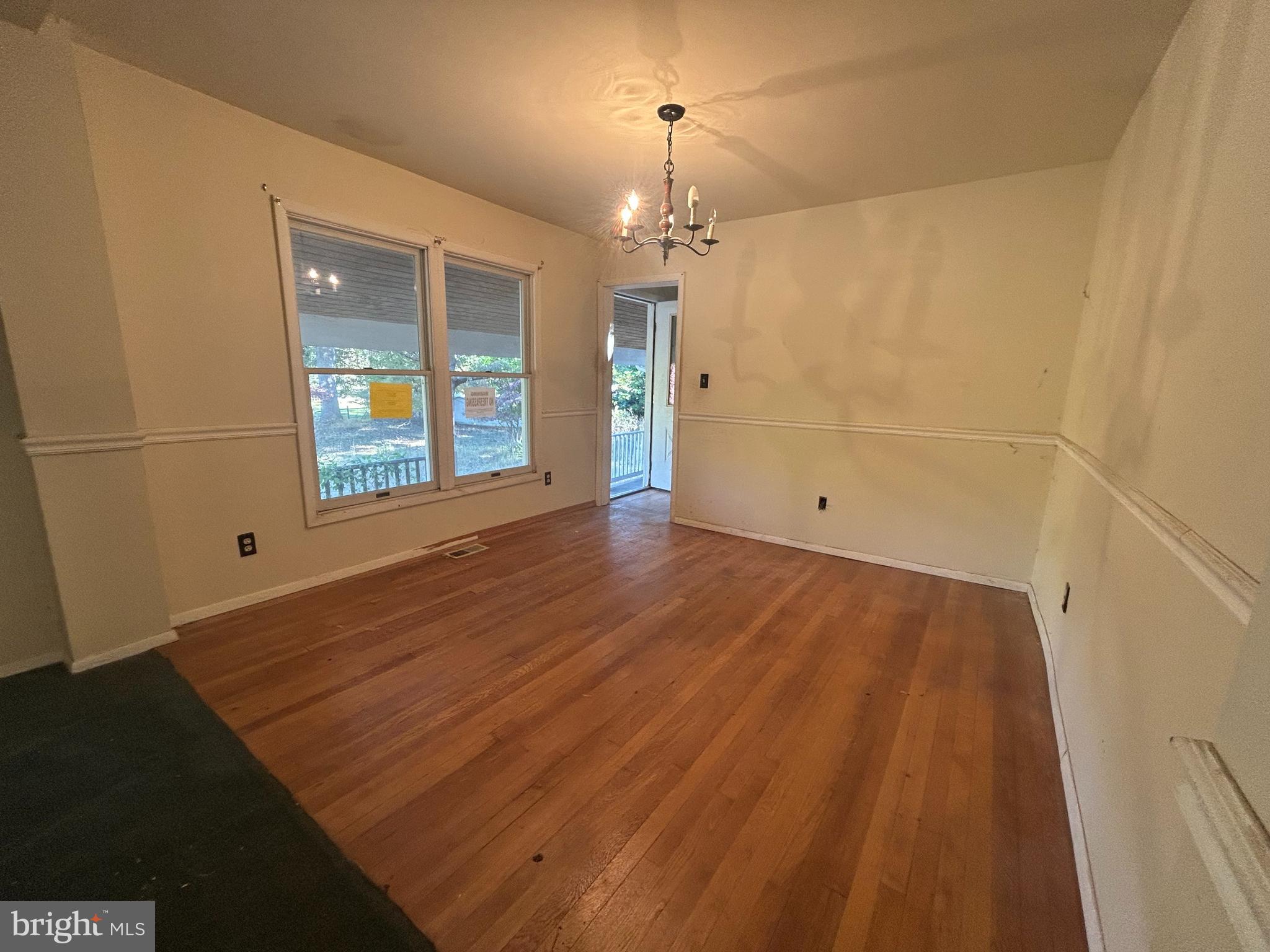 15325 Holly Grove Road Silver Spring, MD 20905 - Photo 19 of 27 wooden floor in an empty room with a window