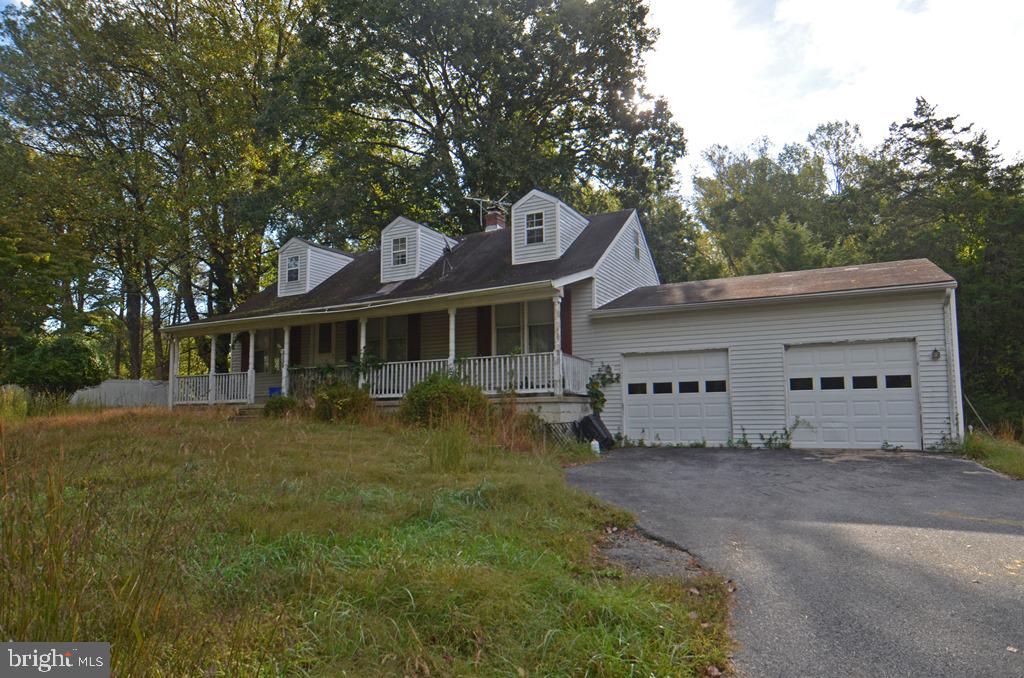 15325 Holly Grove Road Silver Spring, MD 20905 - Photo 2 of 27 a front view of a house with a garden and trees