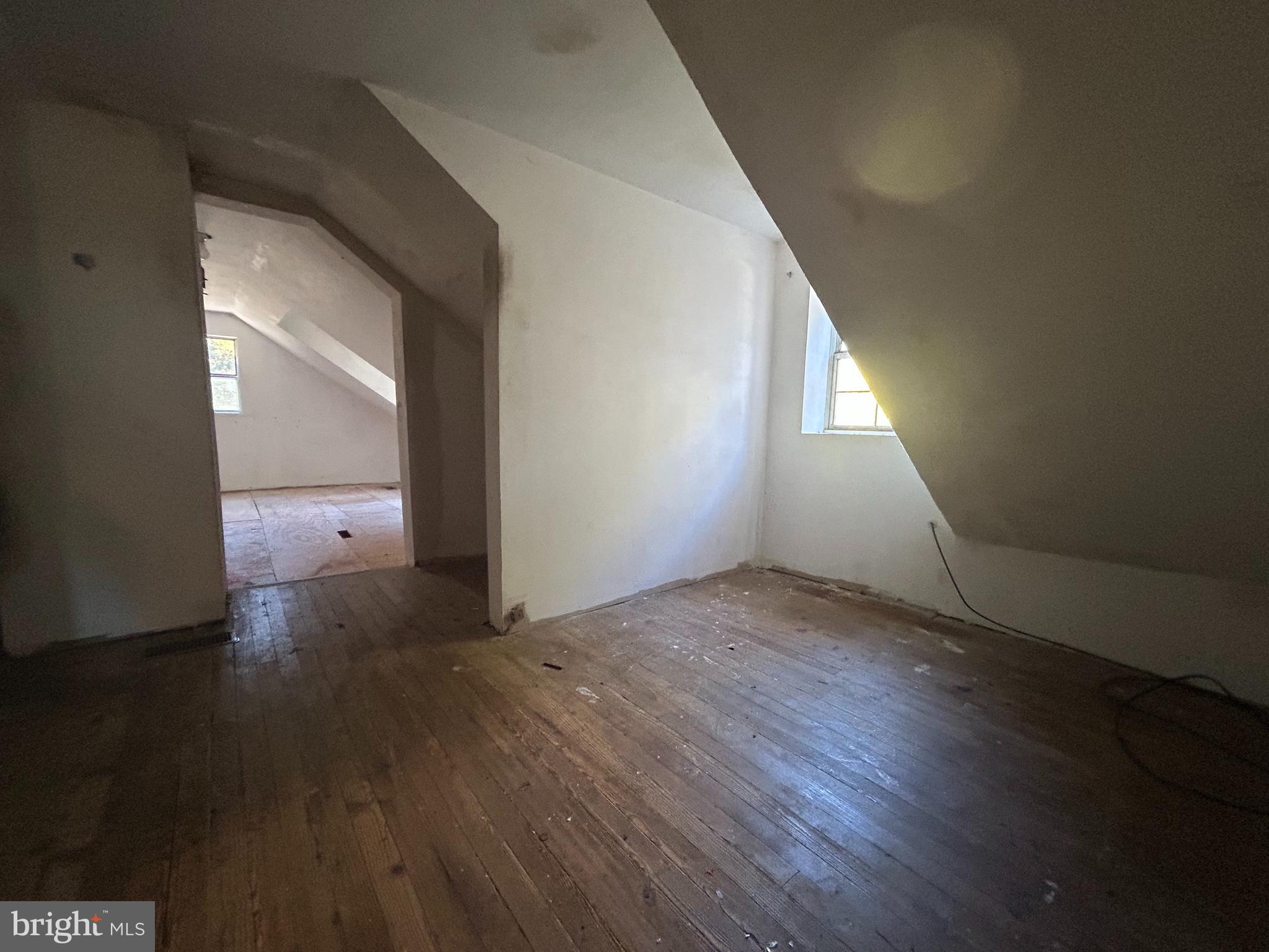 15325 Holly Grove Road Silver Spring, MD 20905 - Photo 24 of 27 an empty room with wooden floor and windows