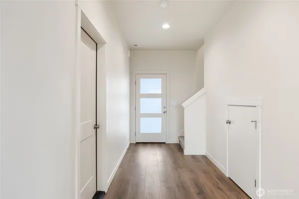 a view of a hallway with wooden floor