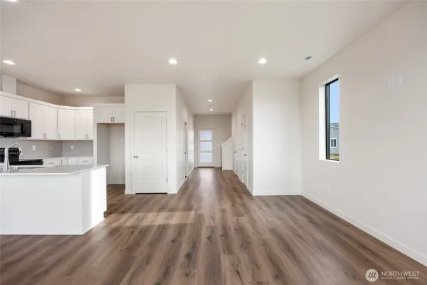 a large kitchen with hardwood floor and a sink
