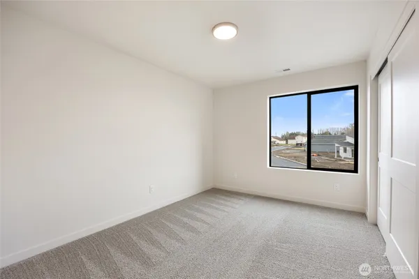 an empty room with closet area