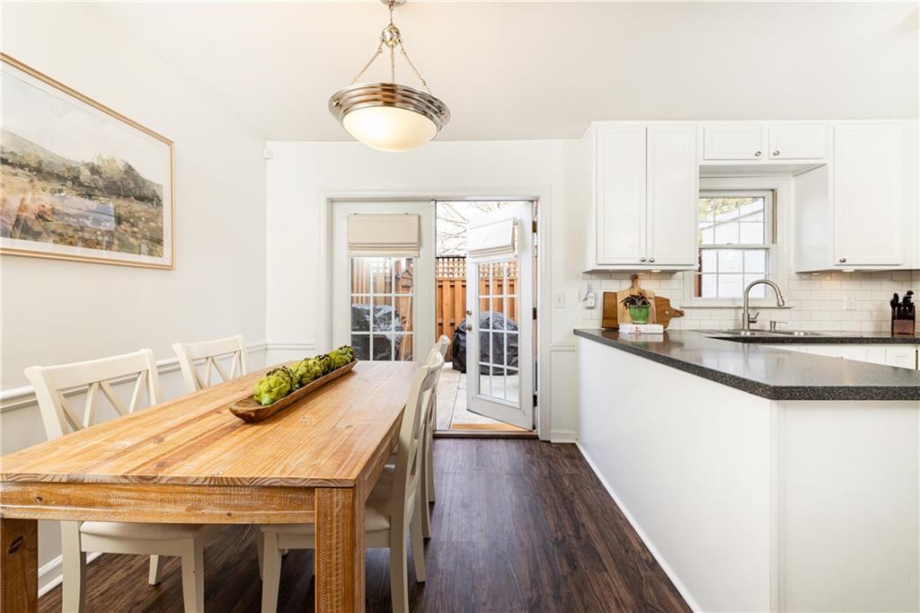 1101 Collier Road Northwest, Unit A4 Atlanta, GA 30318 - Photo 14 of 27 a dining hall with stainless steel appliances granite countertop a stove and a wooden floors