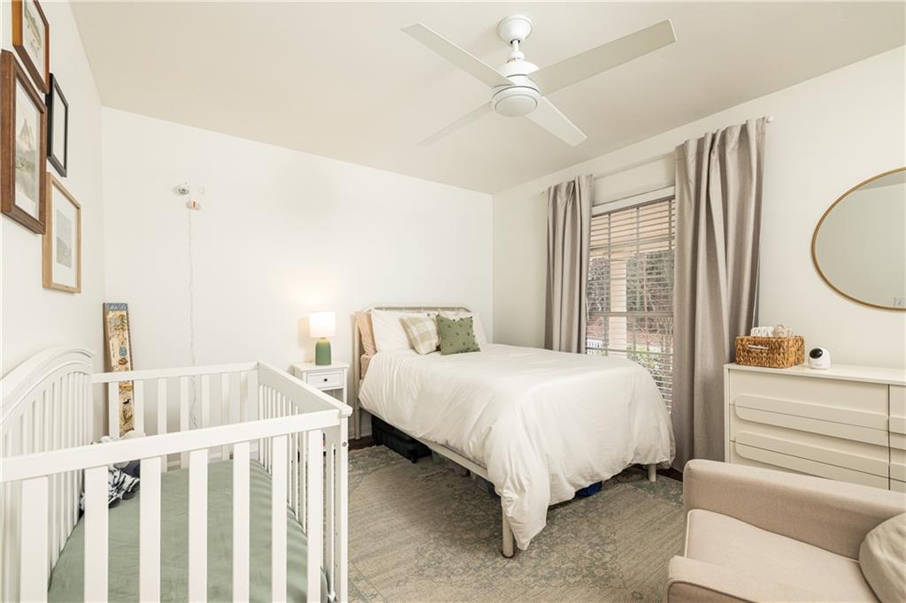 1101 Collier Road Northwest, Unit A4 Atlanta, GA 30318 - Photo 19 of 27 a bedroom with a bed and a chandelier