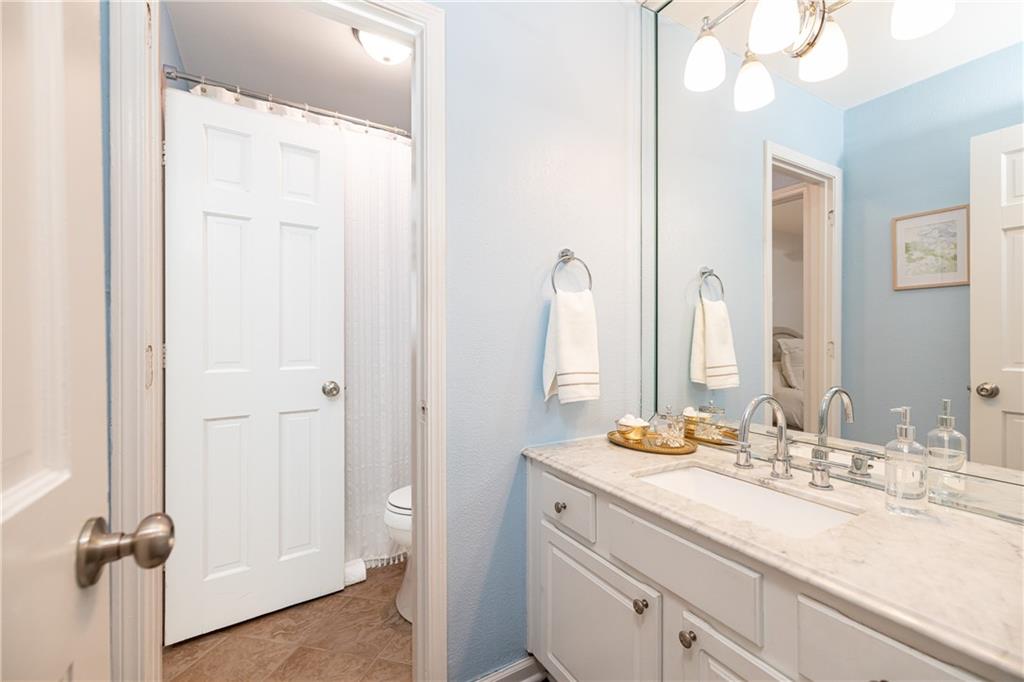 1101 Collier Road Northwest, Unit A4 Atlanta, GA 30318 - Photo 24 of 27 a bathroom with a double vanity sink mirror and shower