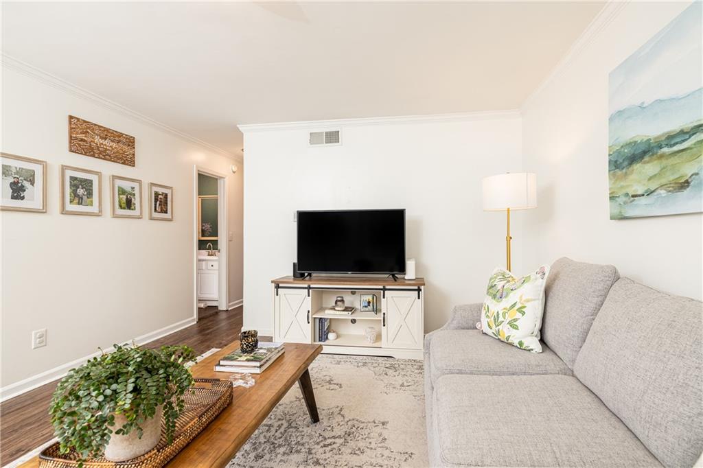 1101 Collier Road Northwest, Unit A4 Atlanta, GA 30318 - Photo 7 of 27 a living room with furniture and a flat screen tv