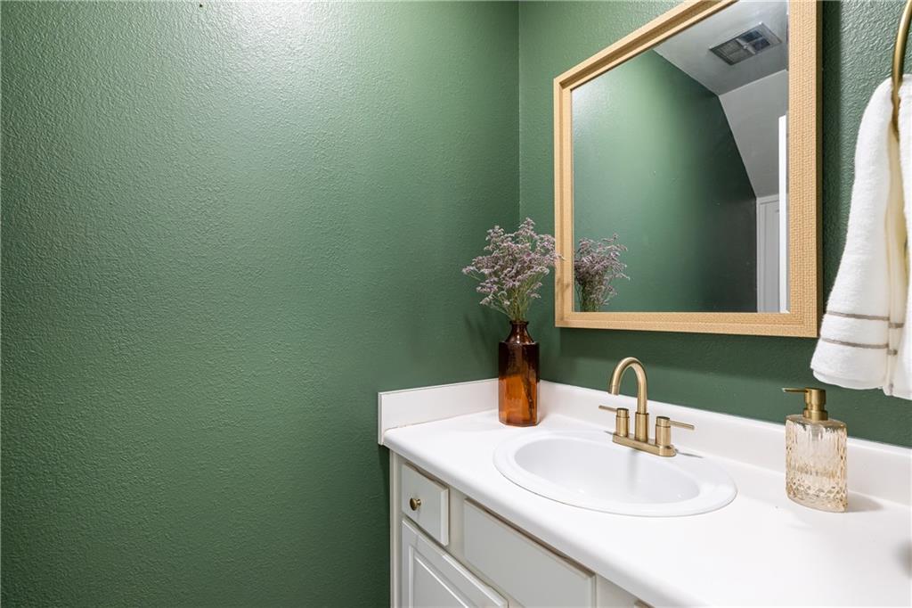 1101 Collier Road Northwest, Unit A4 Atlanta, GA 30318 - Photo 9 of 27 a bathroom with a sink and a mirror