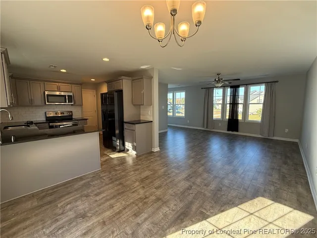 a view of a kitchen with a stove cabinets and wooden floor