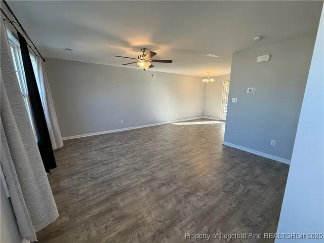 wooden floor in an empty room with a bathroom