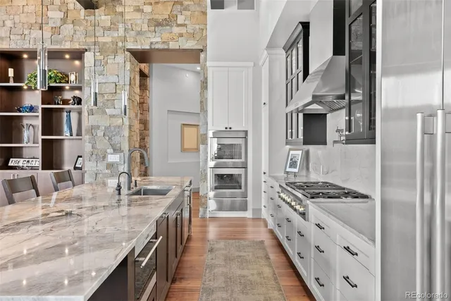 a kitchen with stainless steel appliances granite countertop a stove and a refrigerator