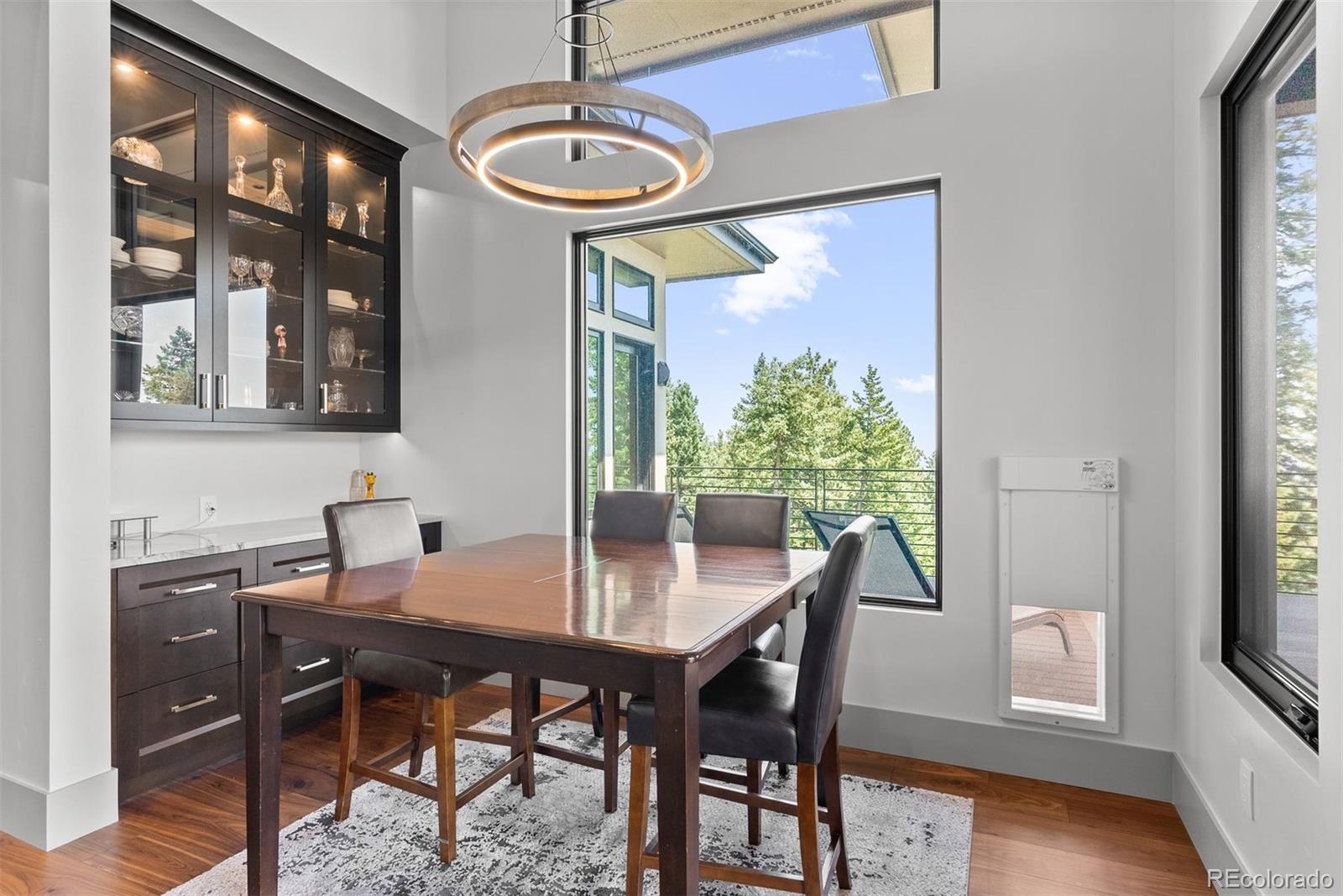 1082 West Meadow Road Evergreen, CO 80439 - Photo 18 of 50 a view of a dining room with furniture window and wooden floor
