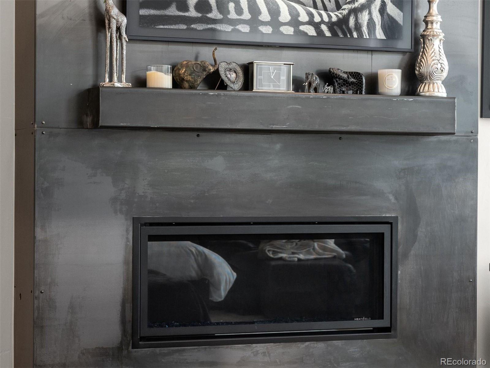 1082 West Meadow Road Evergreen, CO 80439 - Photo 22 of 50 a close view of a fireplace with wooden floor
