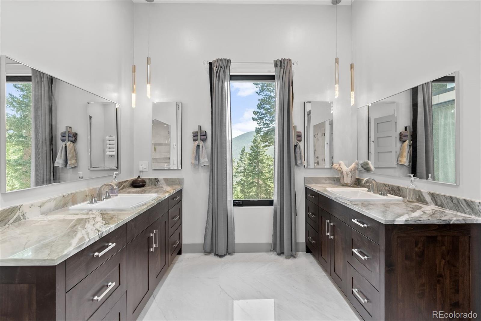1082 West Meadow Road Evergreen, CO 80439 - Photo 25 of 50 a bathroom with a granite countertop double vanity sink and a mirror