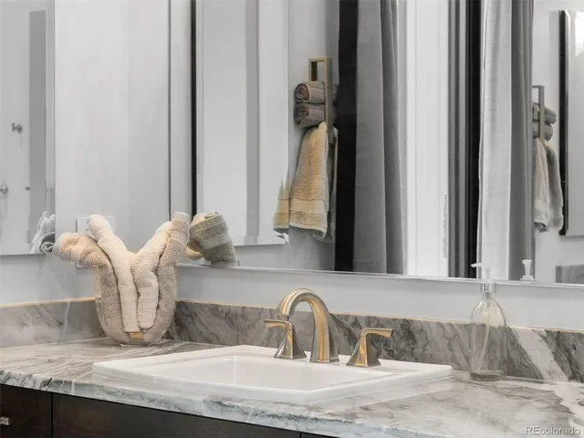 a living room with stainless steel appliances kitchen island granite countertop furniture a rug and a view of kitchen